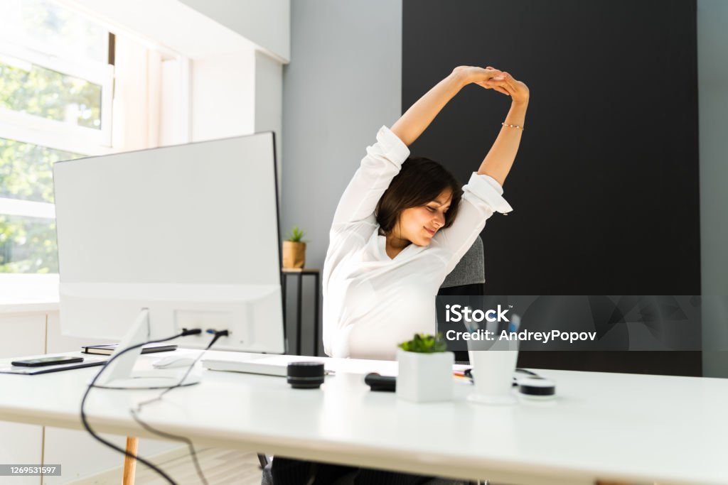 Woman Stretches At Office Desk. Stretch Exercise On Chair
