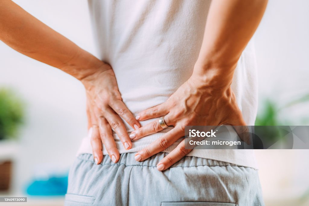 Sciatica or sciatic nerve inflammation, lower back pain. Woman with sciatic nerve pain in her lower back.