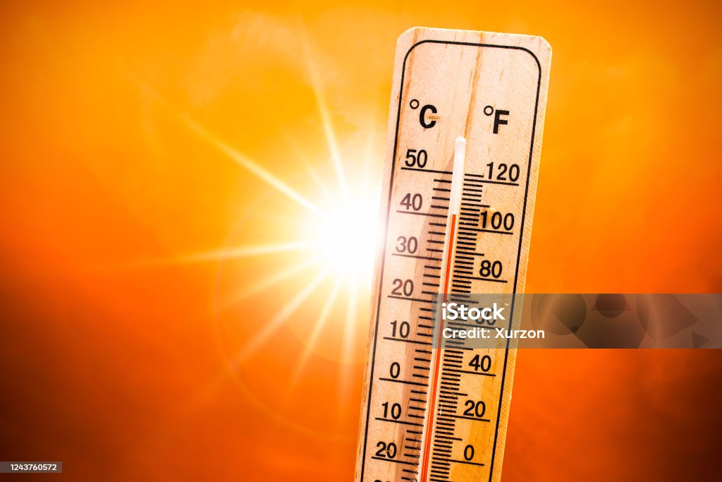 Background for a hot summer or heat wave, orange sky with with bright sun and thermometer