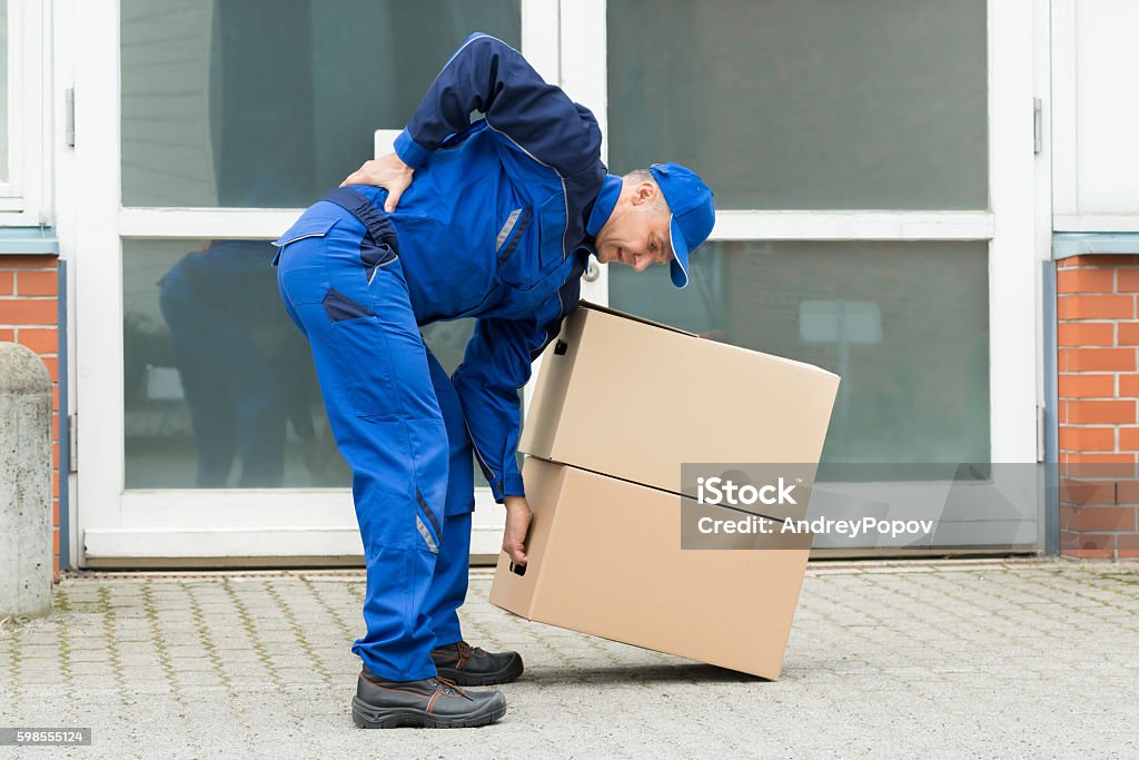 Delivery Man Suffering From Backpain While Lifting Boxes